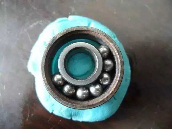 隨后將內圈擠到鋼珠那邊，使鋼珠卡在凹槽中間